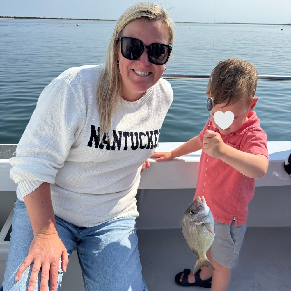 Mom and son on fishing boat with fish in Nantucket Massachusetts