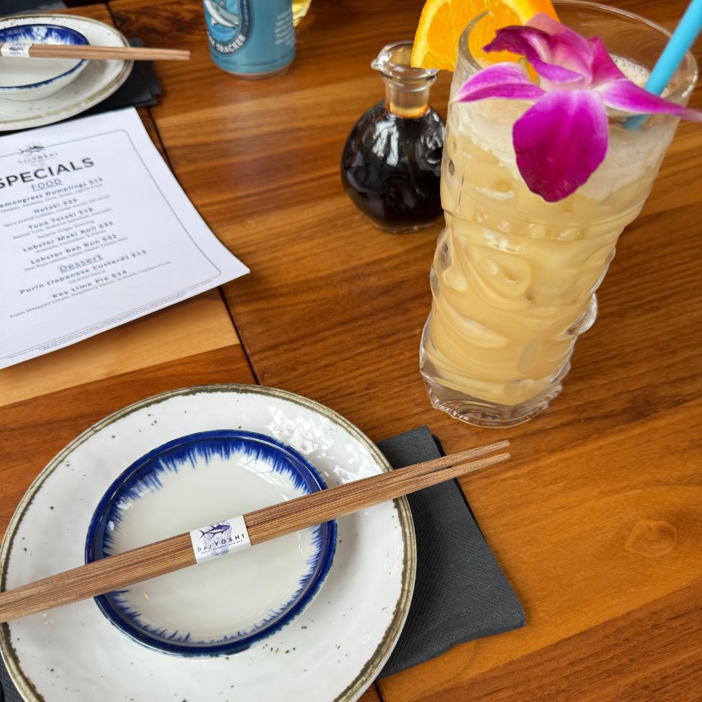 Place settings, chop sticks and a cocktail on a table at Bar Yoshi Nantucket
