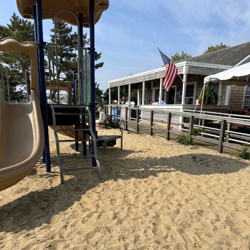 Playground and GypSea Cafe building with American flag at Children's Beach Nantucket