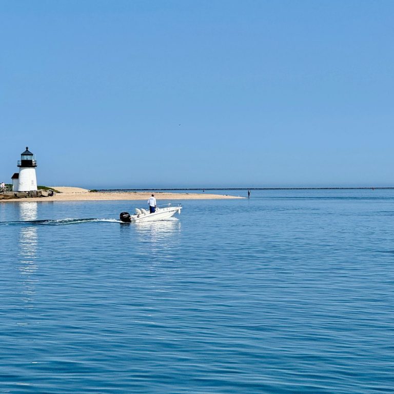 Nantucket harbor lighthouse and boat sunny summer day