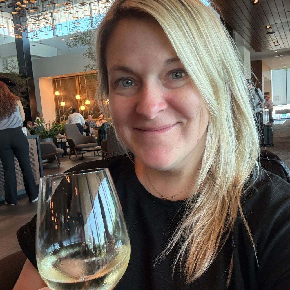 woman holding glass of white wine