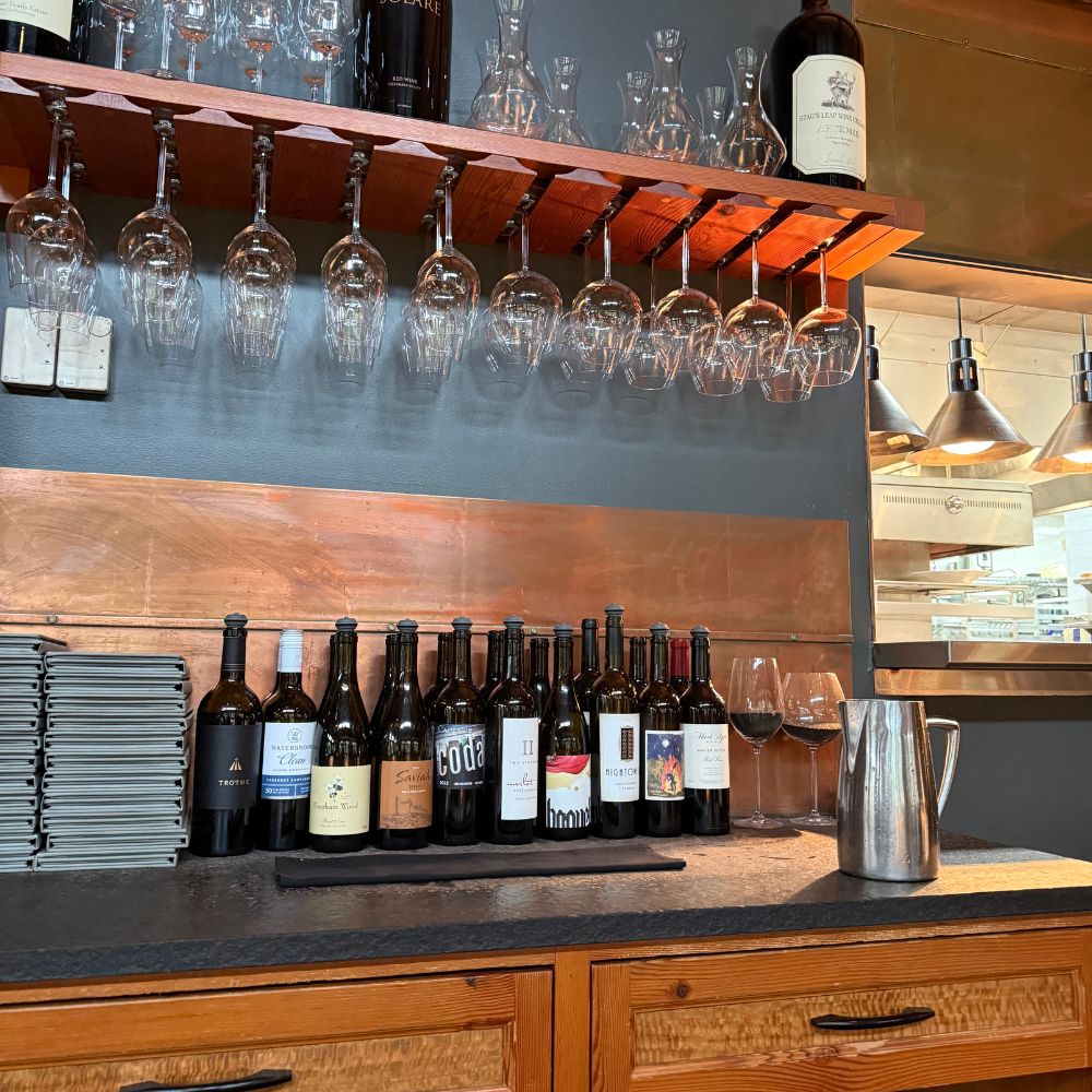 Wines and wine glasses on wall at Barking Frog