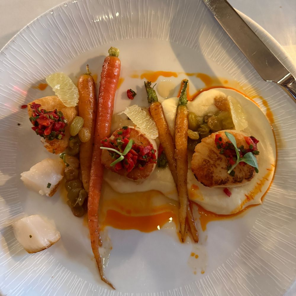 Scallops, potatoes and carrots on plate at Barking Frog