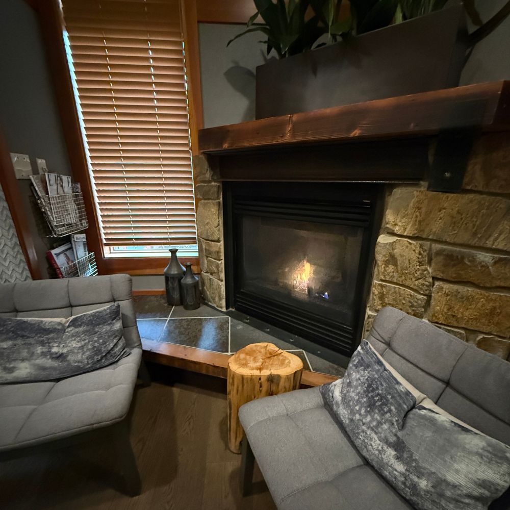 Fireplace and seating inside spa waiting room at Willows Lodge Spa